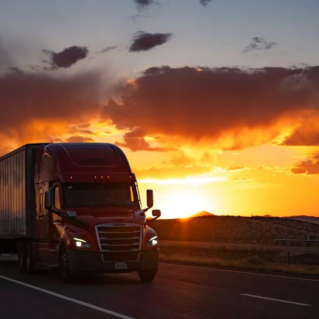 Semi Truck Silhouetted Against the Setting Sun